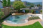 Uniquely shaped outdoor pool in the backyard of a house in an urban area