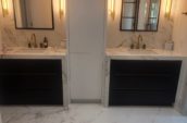 a bathroom with two sinks and a mirror