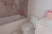 a white bathroom with a walk in shower