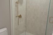 a white bathroom with a walk in shower