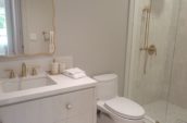 a white bathroom with a walk in shower